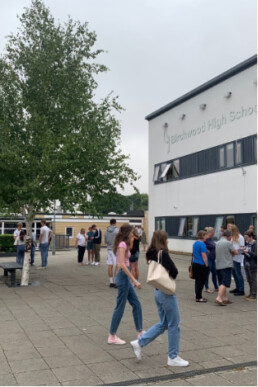 Photo of students, parents and staff at Birchwood High School on the morning of their A-Level results